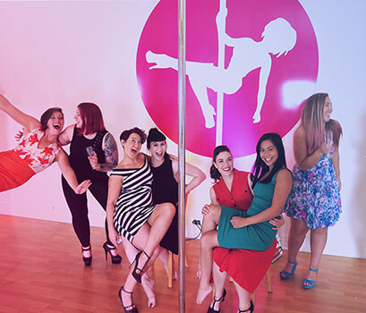 group of woman in a pole dancing studio