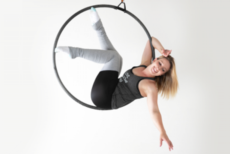 woman lying on lyra hoop